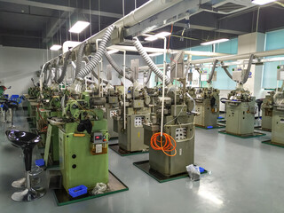 A series of lathes for watchmaking at a factory in China. Production of parts at the production site. Workshop