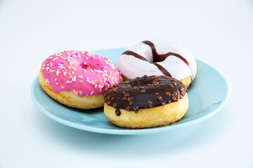 Three different kind of donuts on a plate