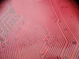 Selective focus. Close up photo of red printed circuit board with dip components. LED diods, resistors, capasitors and processor on the background
