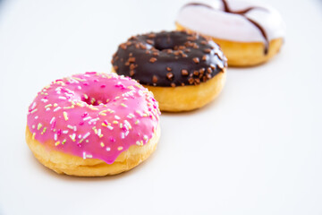 Three different kind of donuts isolated on white.