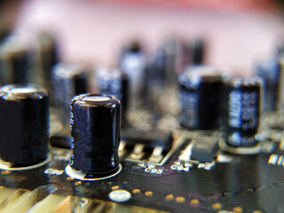 Fototapeta na wymiar Selective focus. Close up photo of black printed circuit board with dip components. LED diods, resistors, capasitors and processor on the background