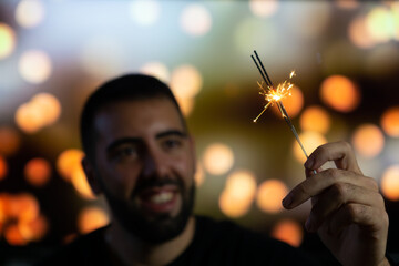 Young man with a lit flare holding it in her hands