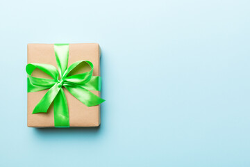 Holiday present box over colored background, top view. Copy space for design