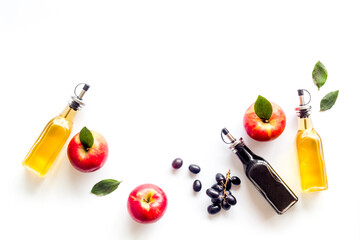 Red wine and apple cider vinegar with grapes and red apples