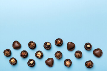 Different kinds of chocolates on colored table close-up. Top View and Flat Lay with copy space