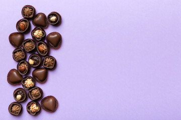 Different kinds of chocolates on colored table close-up. Top View and Flat Lay with copy space