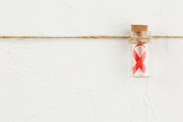 Glass bottle with a red ribbon inside.