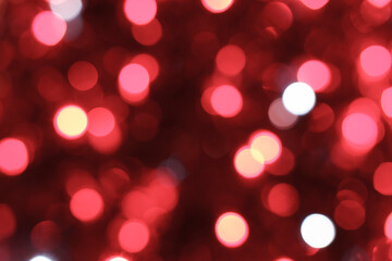 Red bokeh background. Texture foil and blurred confetti, light of golden dust. Festive party...