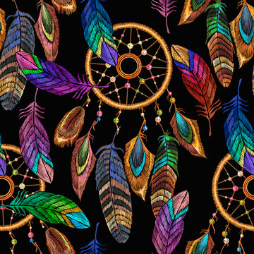 Embroidery dream catcher and feathersseamless pattern. Native american indian talisman. Magic tribal  background, t-shirt design. Template for clothes ethnic style