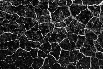 abstract black background with white cracks overlay ground cracked drought, old paint