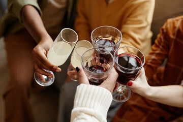 Close-up of group of people toasting with glasses with champagne and wine during party