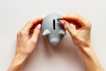 Piggy bank in hands top view. Family budget concept