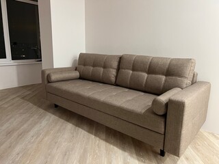 beige sofa on a white wall background