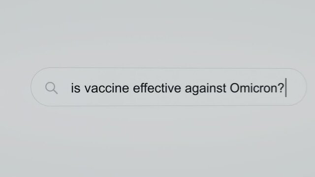 Is vaccine effective against Omicron? - Pc screen internet browser search engine bar typing vaccine related question.