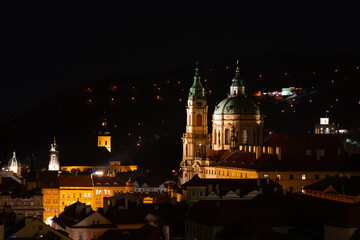 Fototapeta na wymiar Prague at night, view of the Basilica of St. Mikulas, cityscape