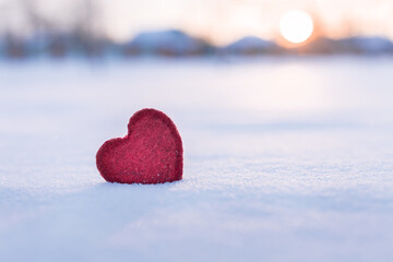 Fototapeta premium red heart in winter on snow at sunset, i love winter concept,