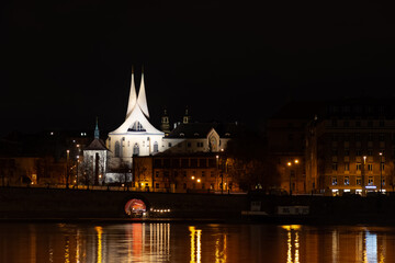 Fototapeta na wymiar Prague at night, Emmaus monastery, reflection of lights in the river