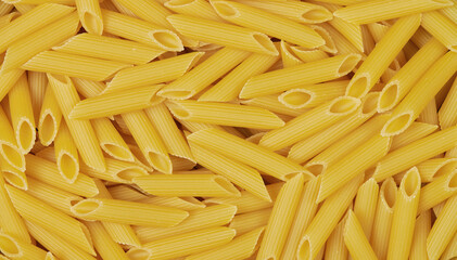 uncooked penne pasta background and texture