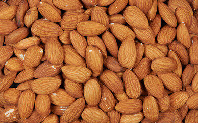 Heap of peeled almonds. Nuts background and texture