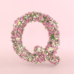 Creative letter Q concept made of fresh Spring wedding flowers. Flower font concept on pastel pink background.