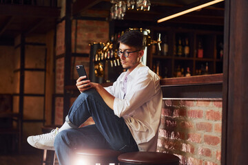 Having a rest. Man in casual clothes sitting in the pub