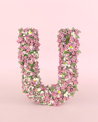 Creative letter U concept made of fresh Spring wedding flowers. Flower font concept on pastel pink background.