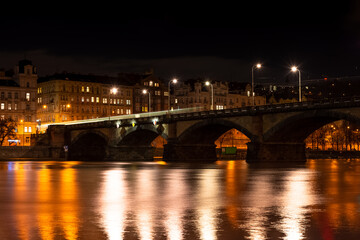 Prague at night, view of bridges on the Vlatava river, reflection of night city lights, cityscape