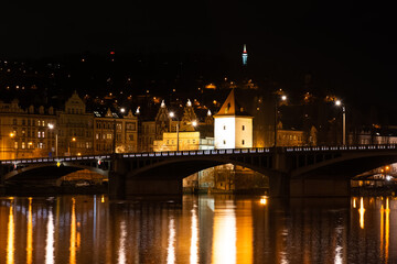 Obraz premium Prague at night, view of bridges on the Vlatava river, reflection of night city lights, cityscape