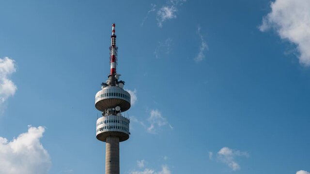 Time lapse video of TV tower with beautiful moving clouds in front of blue sky, Snezhanka TV tower on Snezhanka Peak in Pamporovo resort, Rhodopi Mountains, Bulgaria