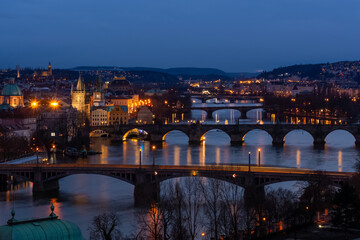 Prague at night, view of bridges on the Vlatava river, reflection of night city lights, cityscape