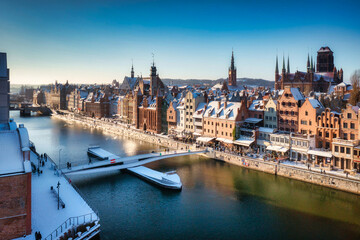 Medieval port crane in Gdansk over the Motlawa river at snowy winter, Poland