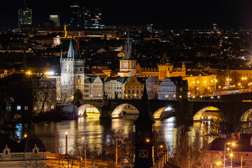 Fototapeta na wymiar Prague at night, Charles bridge, reflection of lights in the Vltava river, cityscape
