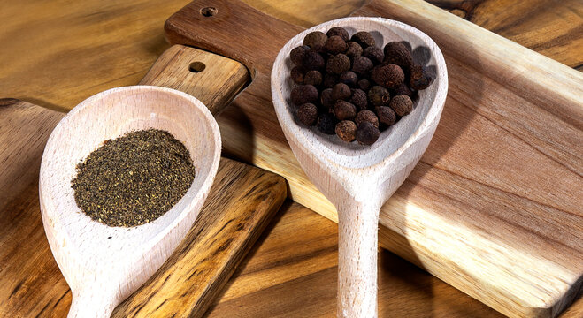 Black Papper In Spoon On The Wooden Cutting Board