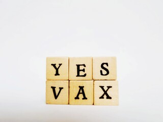 written yes vax with wooden cubes on white background