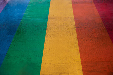 zebra crossing painted in LGBT flag colors, concept pride month