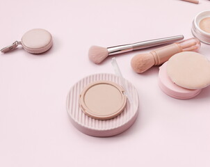 Make up layout, accessories and face powder on pastel pink background. Minimal and luxury make up, cosmetic or beauty salon composition. Flat lay, top view, copy space.