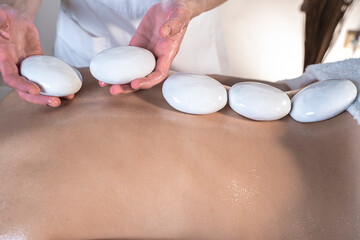 woman enjoying stone back massage