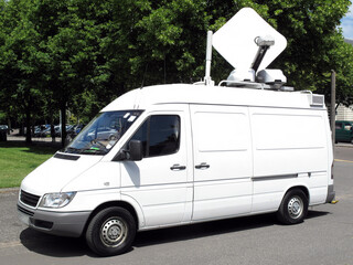 Outside broadcast white media vehicle van broadcasting breaking news information used in ...