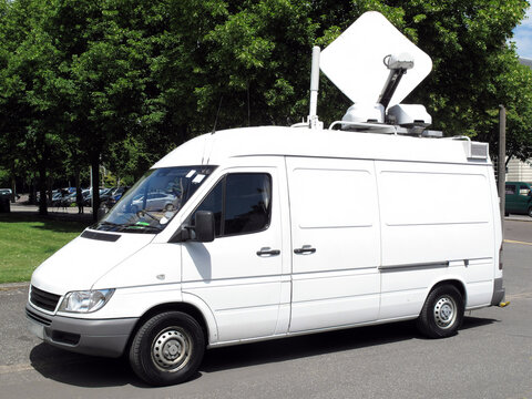 Outside broadcast white media vehicle van broadcasting breaking news information used in  television journalism stock photo image