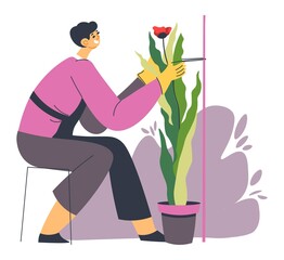 Gardener tending plants, florist shop or store