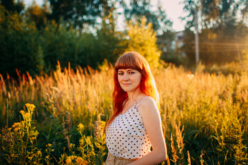 red hair woman outdoors on summer background
