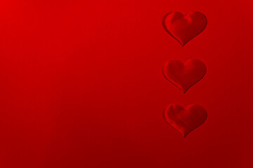 Three hearts on a red background with copy space for valentine's day.