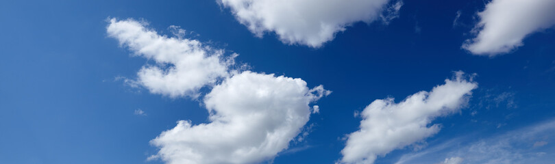 Panoramic photo of blurred sky. Blue sky background with cumulus clouds