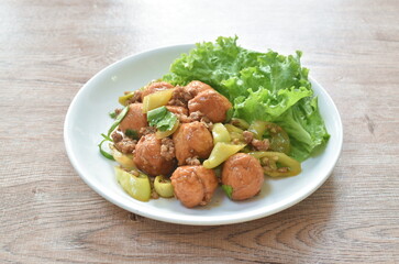 deep fried fish tofu ball with chop pork topping slice sweet green chili in sauce on plate