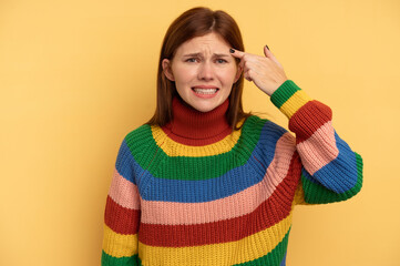 Young English woman isolated on yellow background showing a disappointment gesture with forefinger.