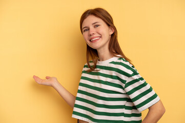 Young English woman isolated on yellow background showing a welcome expression.