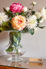 Flower vase and apartment hotel room keys. Still life
