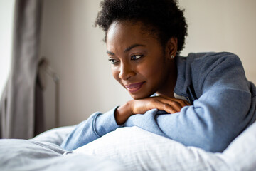 Close up African American woman relaxing in bedroom