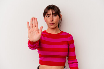 Young Argentinian woman isolated on white background standing with outstretched hand showing stop sign, preventing you.