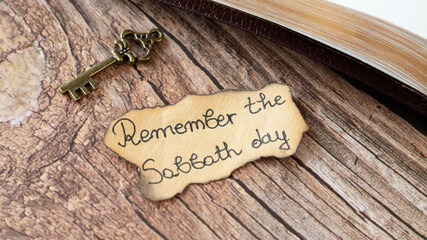Remember Sabbath Day handwritten quote on ancient, old-fashioned paper, vintage rustic key, and...